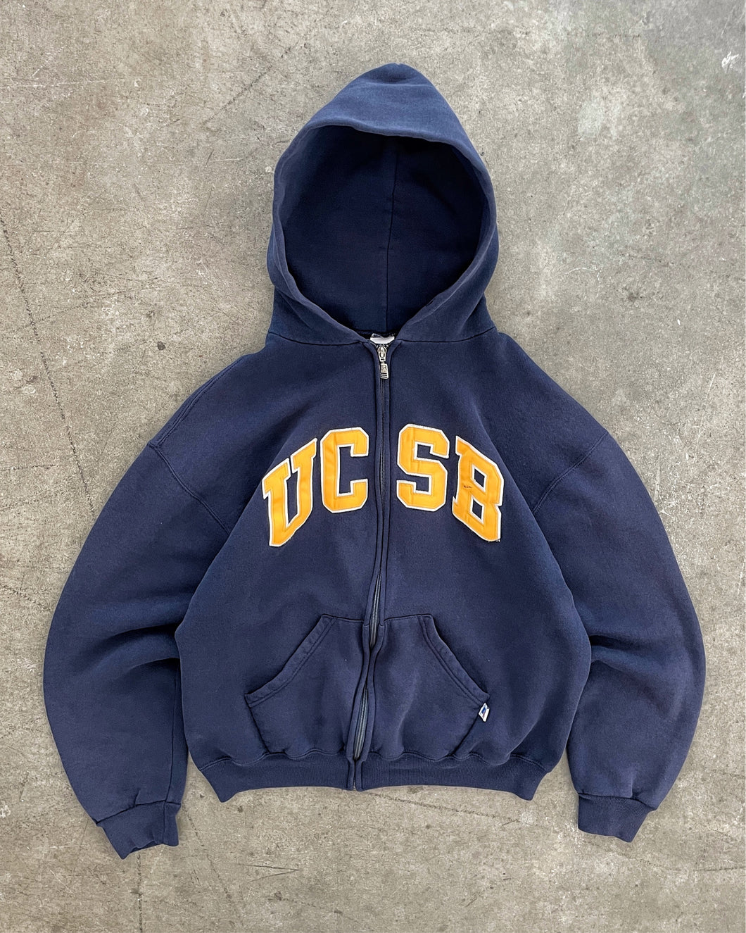 FADED NAVY BLUE “UCSB” RUSSELL ZIP UP HOODIE - 1990S
