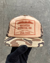 Load image into Gallery viewer, “WASATCH DISPOSAL INC.” CAMO FOAM TRUCKER HAT - 1990S
