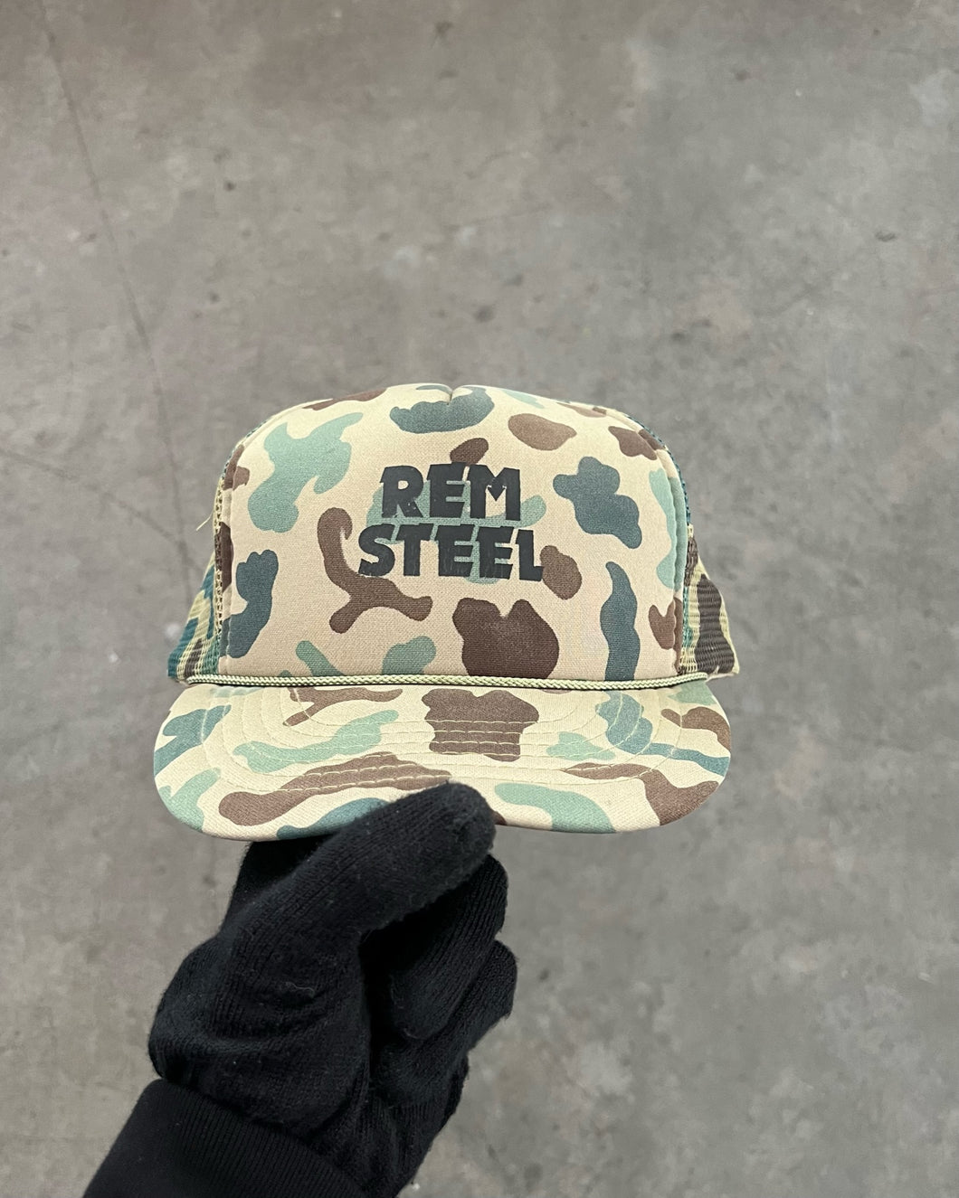 CAMOUFLAGED “REM STEEL” TRUCKER HAT - 1980S